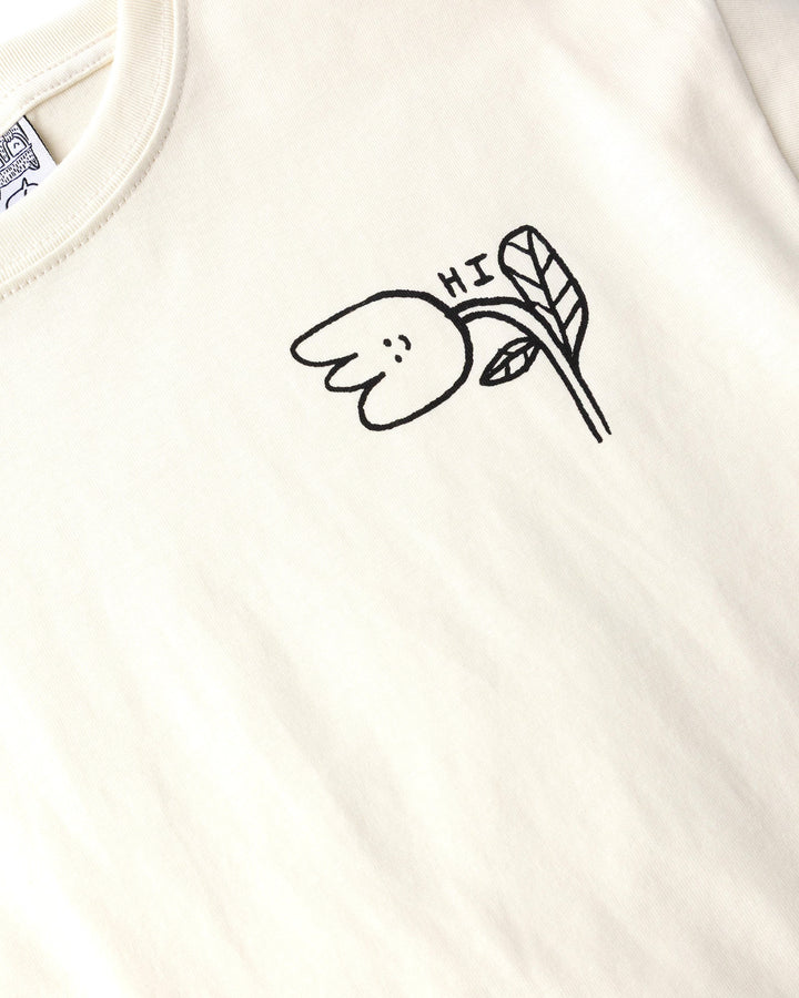 Close up of the Pocket Flower Tee print in cream