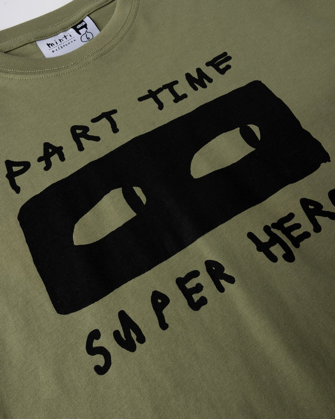 Close up of the Part Time Super Hero Tee print in light khaki