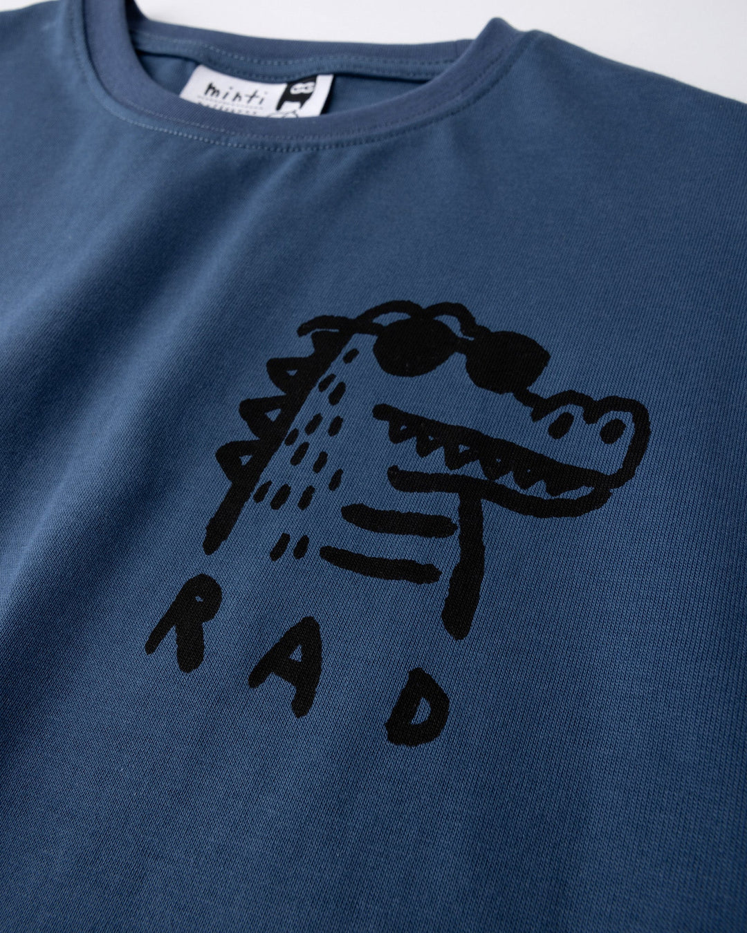 Close up of the Rad Croc Tee print in blue