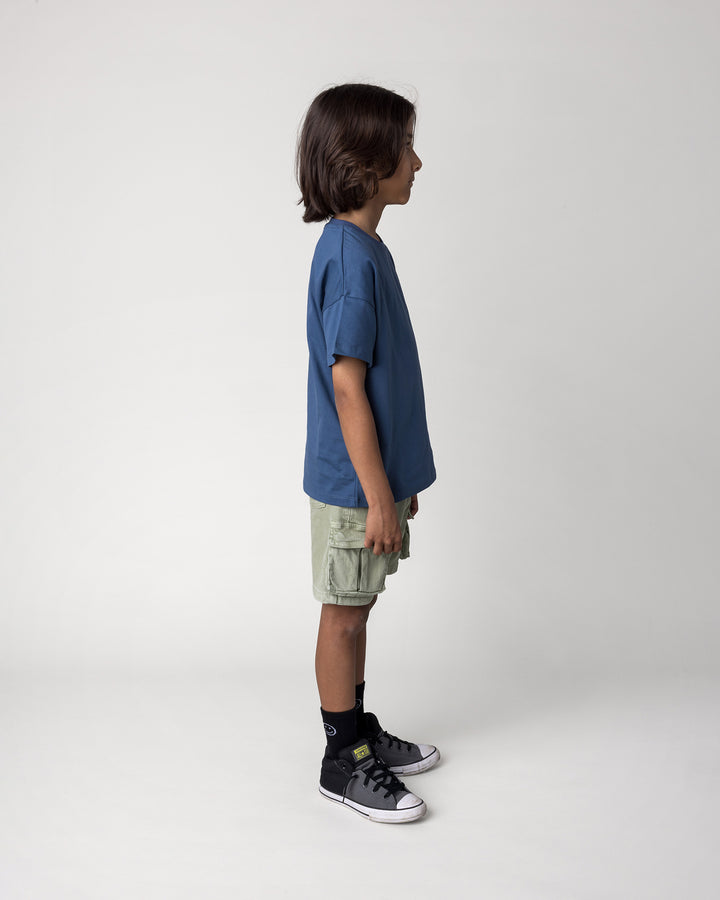 Kid wearing the Rad Croc Tee in blue, side view