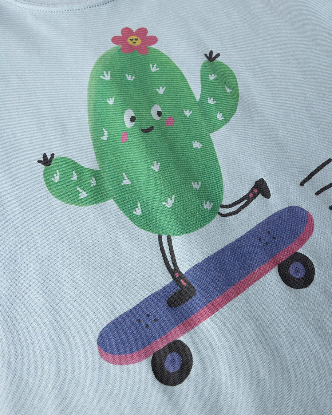 Close up of the Skate Cactus Tee print in light blue