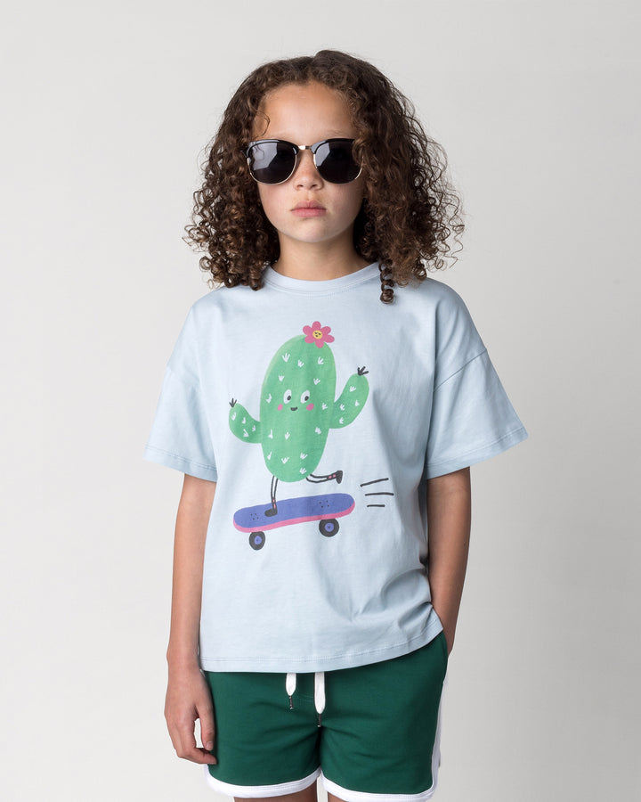 Close up of the Skate Cactus Tee in light blue on a kid, front view