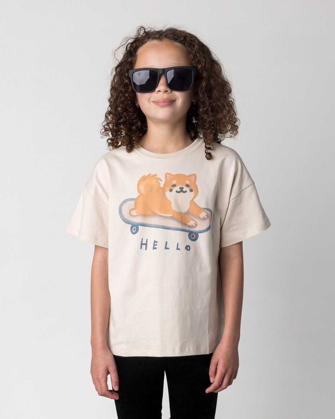Close up of the Skate Puppy Tee in stone on a kid, front view