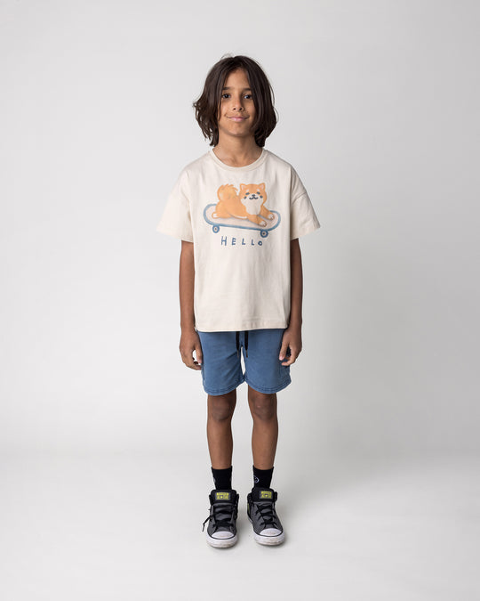 Kid wearing the Skate Puppy Tee in stone with the Blasted Deluxe Cargo Short in midnight wash, front view