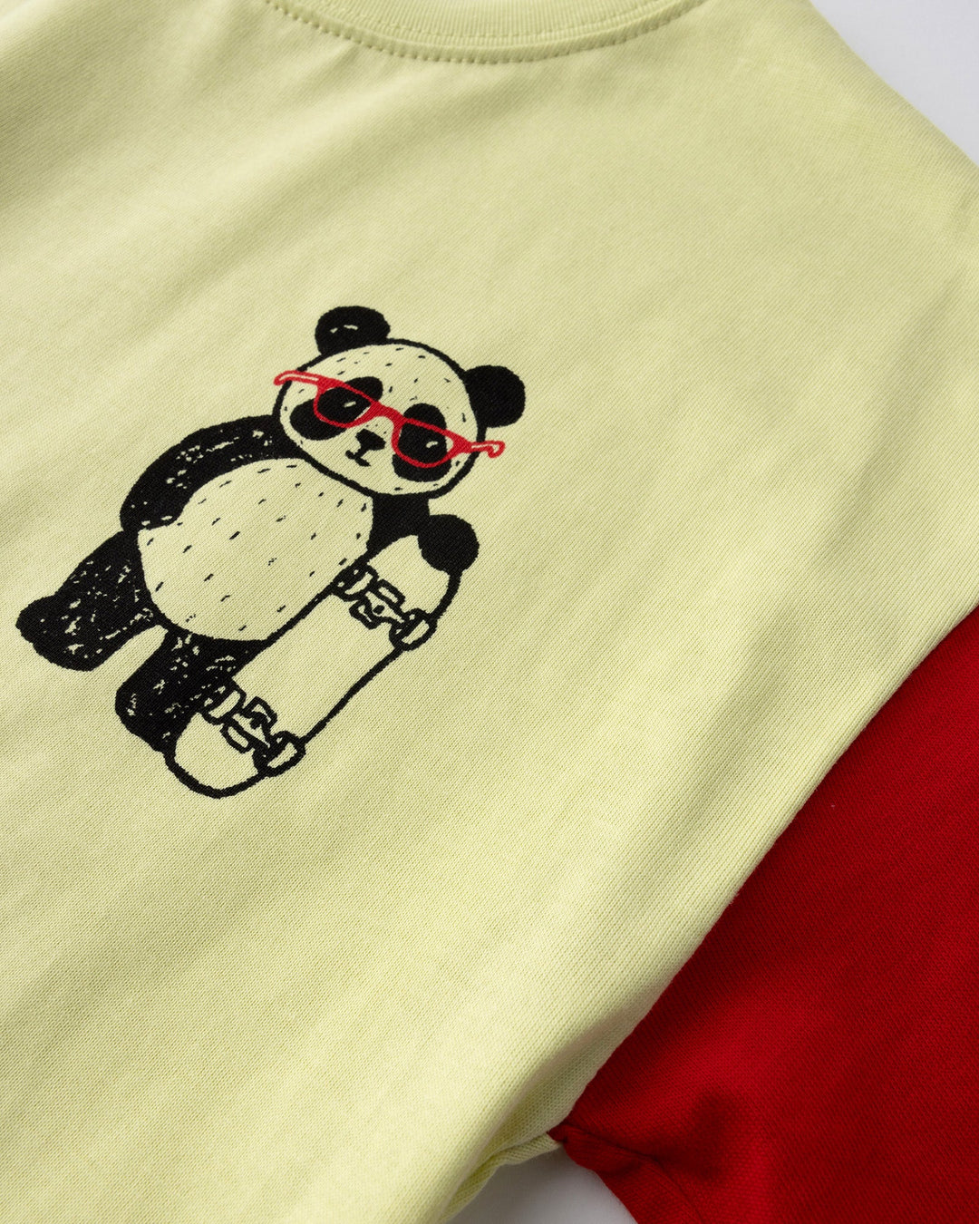 Close up detail of the Skate Panda Tee in light zest, ink and red