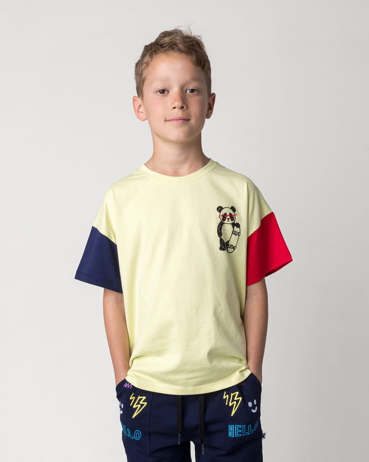 Close up of the Skate Panda Tee in light zest, ink and red on a kid, front view