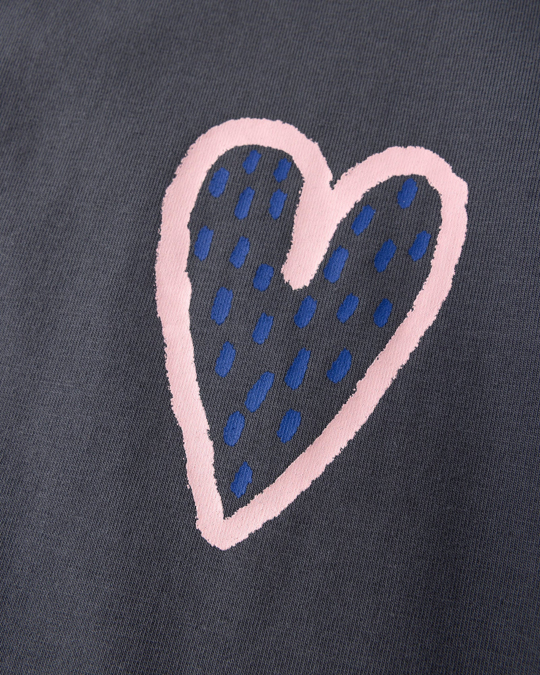 Close up of the Speckle Heart Tee print in dark grey