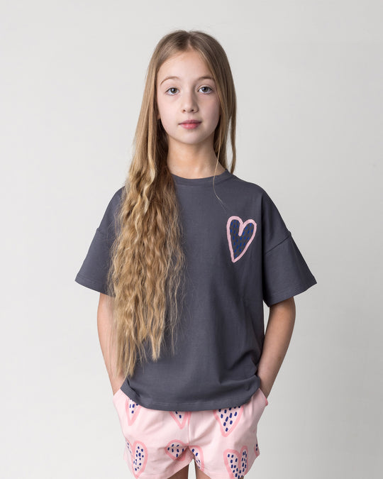 Close up of the Speckle Heart Tee in dark grey on a kid, front view