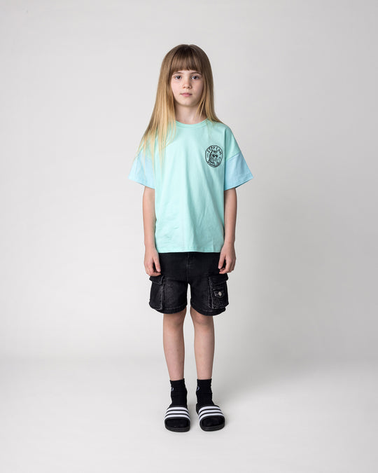 Kid wearing the Stay Cool Tee in seafoam and light aqua, front view