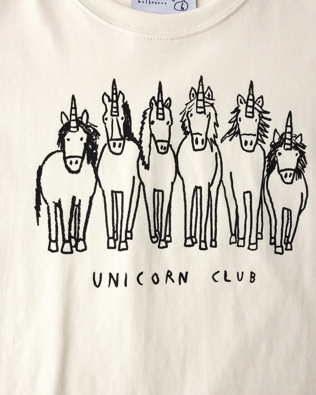 Close up of the Unicorn Club Tee print in cream