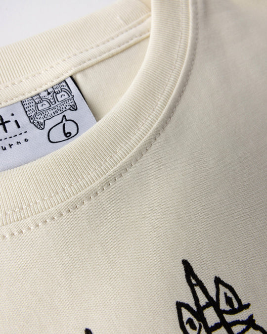 Close up detail of the Unicorn Club Tee in cream
