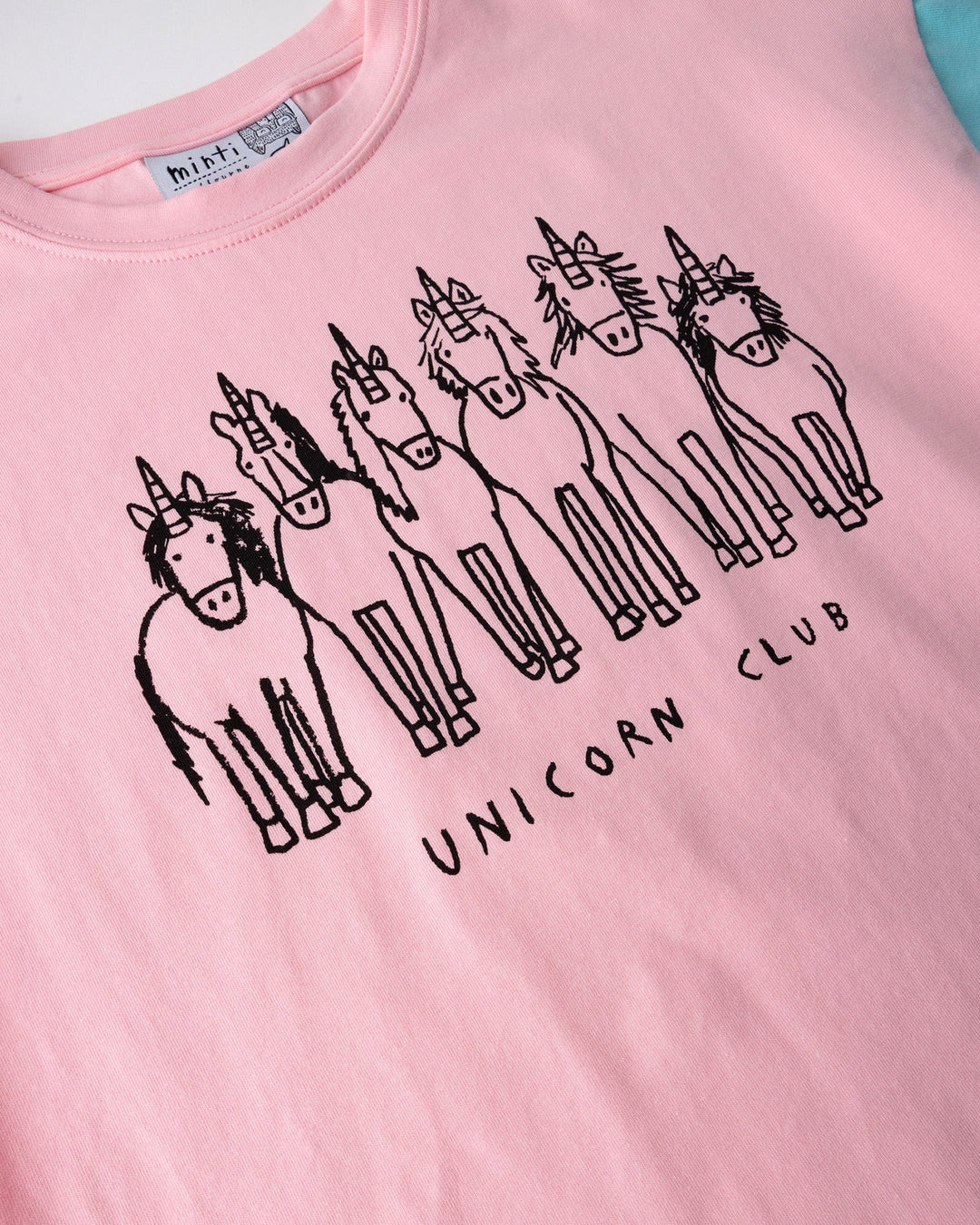 Close up of the Unicorn Club Tee print in pink, hot pink and aqua