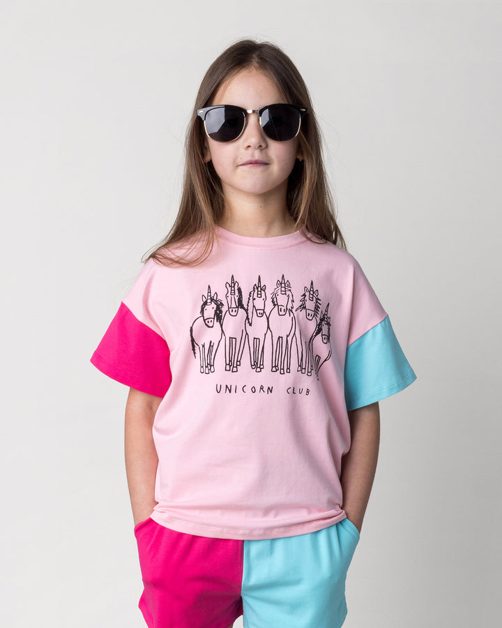 Close up of the Unicorn Club Tee in pink, hot pink and aqua on a kid, front view