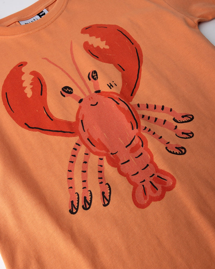 Close up of the Vacay Crayfish Tee print in light orange