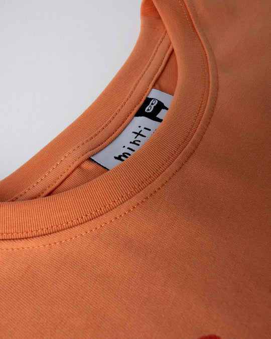 Close up detail of the Vacay Crayfish Tee in light orange
