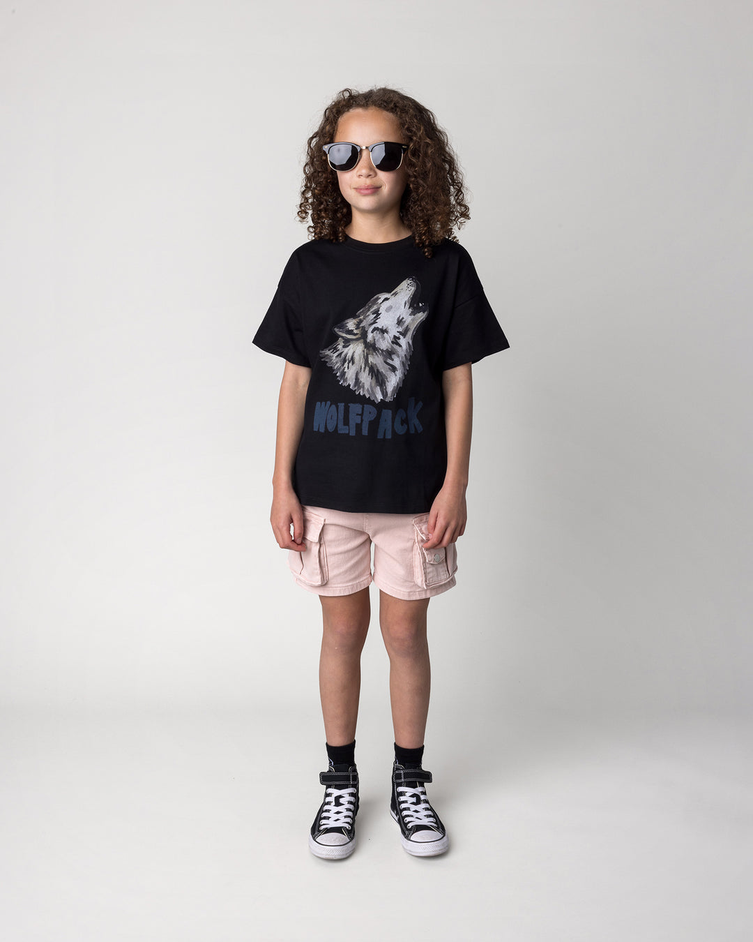 Kid wearing the Wolfpack Tee in black, front view