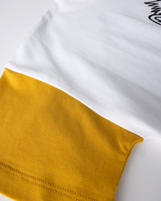 Close up detail of the Werewolf Rockstar Tee in off white, mustard and turf