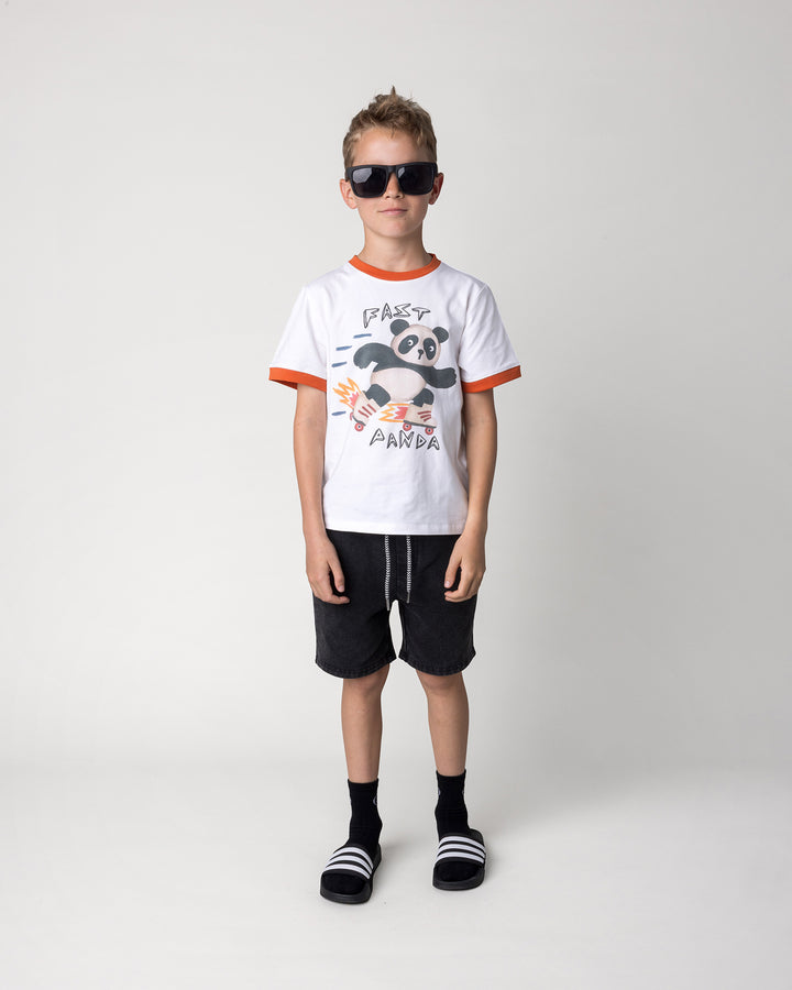 Kid wearing the Fast Panda Tee in white and orange with the Blasted Icon Short in black wash, front view