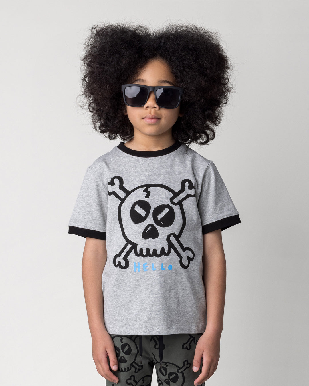 Close up of the Hello Skull Tee in grey marle and black on a kid, front view