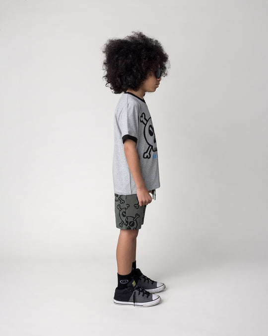 Kid wearing the Hello Skull Tee in grey marle and black with the Hello Skull Short in forest, side view