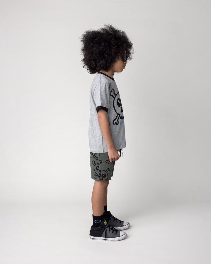 Kid wearing the Hello Skull Tee in grey marle and black with the Hello Skull Short in forest, side view