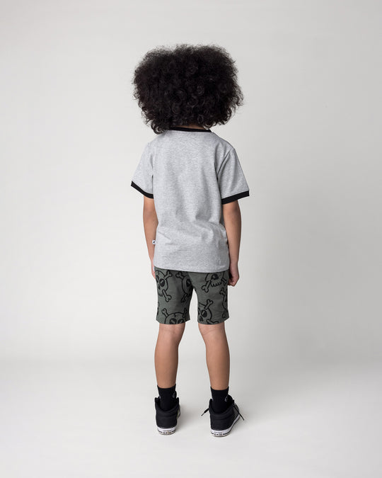Kid wearing the Hello Skull Tee in grey marle and black with the Hello Skull Short in forest, back view