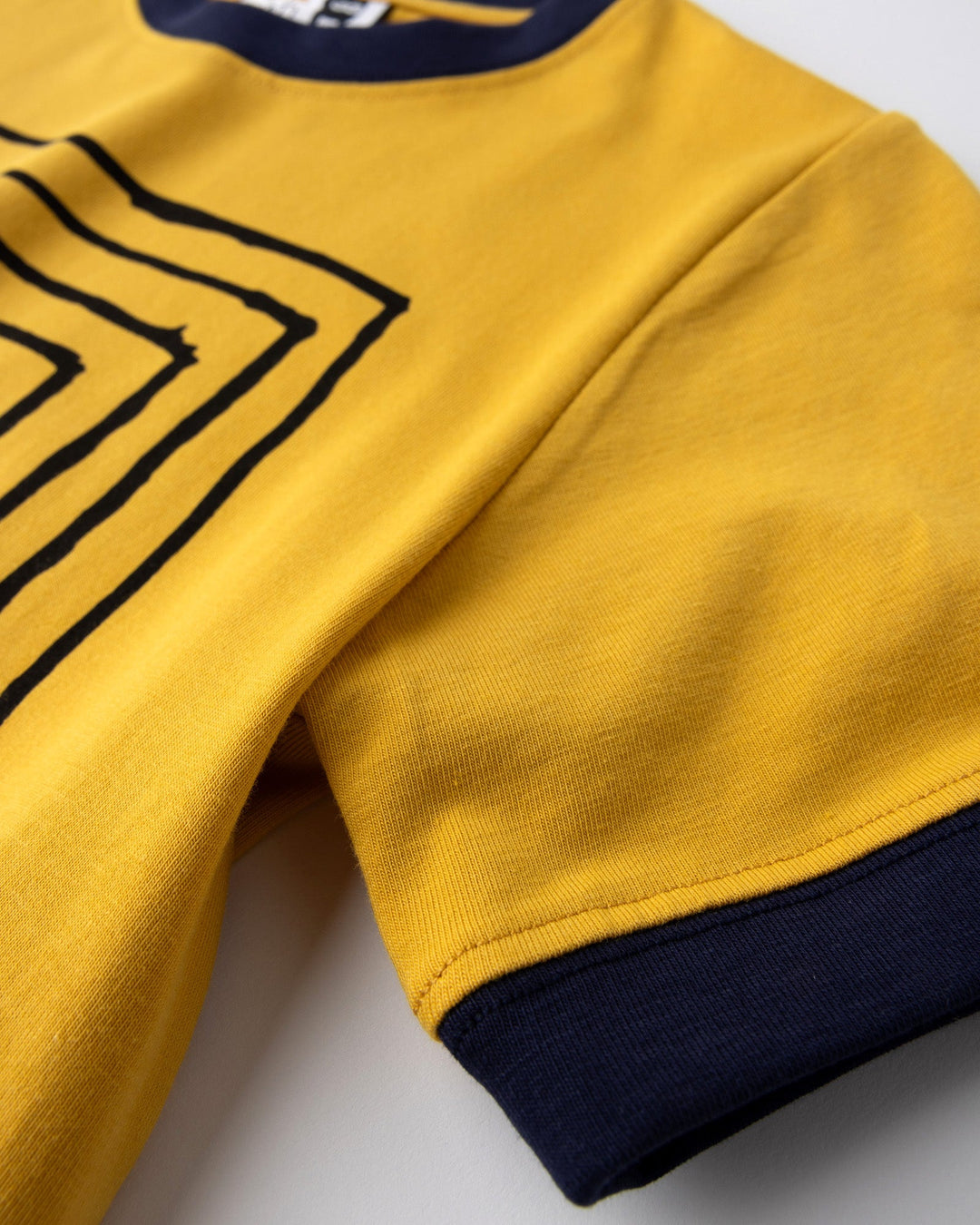 Close up detail of the Hidden Panda Tee in mustard and ink