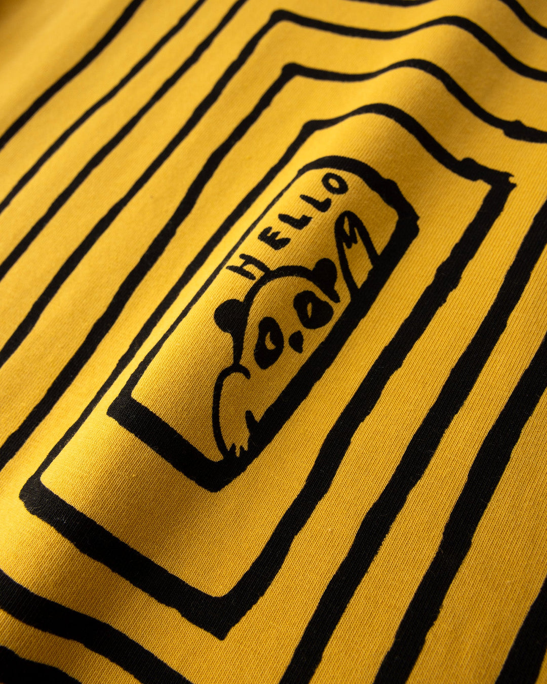 Close up of the Hidden Panda Tee print in mustard and ink