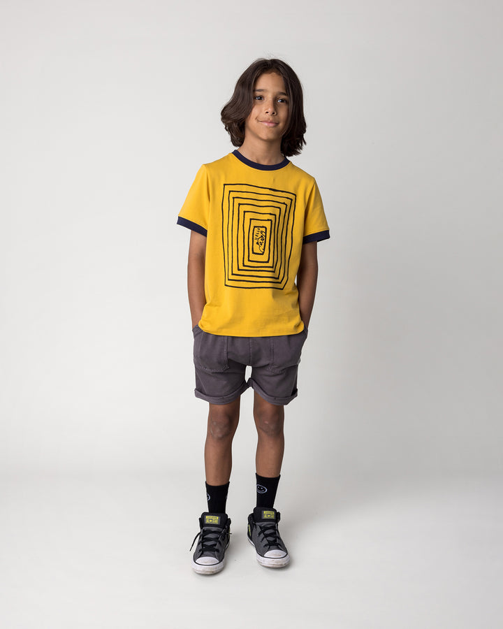 Kid wearing the Hidden Panda Tee in mustard and ink with the Blasted Roller Short in black wash, front view