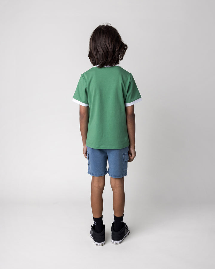 Kid wearing the Hidden Panda Tee in turf and white with the Blasted Deluxe Cargo Short in midnight wash, back view