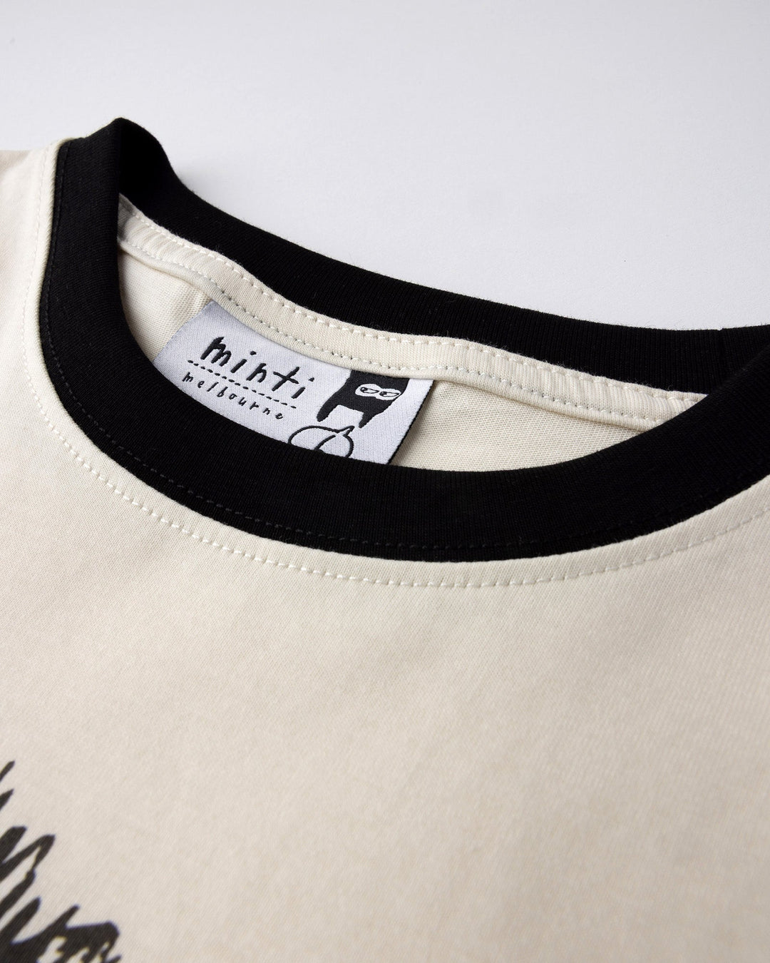 Close up detail of the Mo-Hawk Tee in cream and black