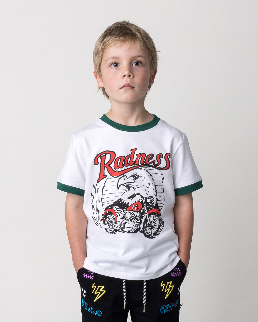 Close up of the Radness Tee in white and jungle on a kid, front view
