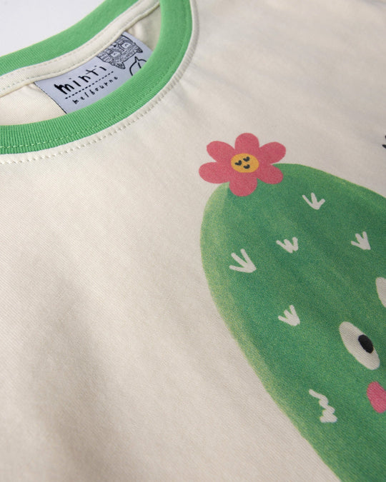 Close up of the Skate Cactus Tee print in cream and green