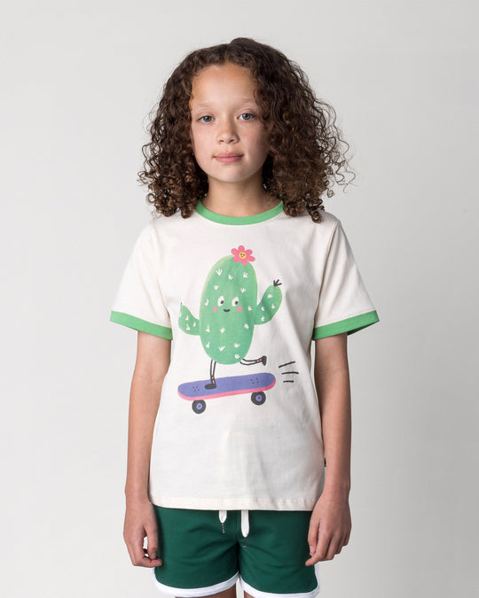 Close up of the Skate Cactus Tee in cream and green on a kid, front view