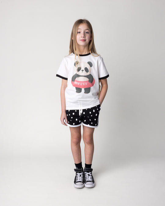 Kid wearing the Swimming Panda Tee in white and black with the Spotty Short in black and white, front view