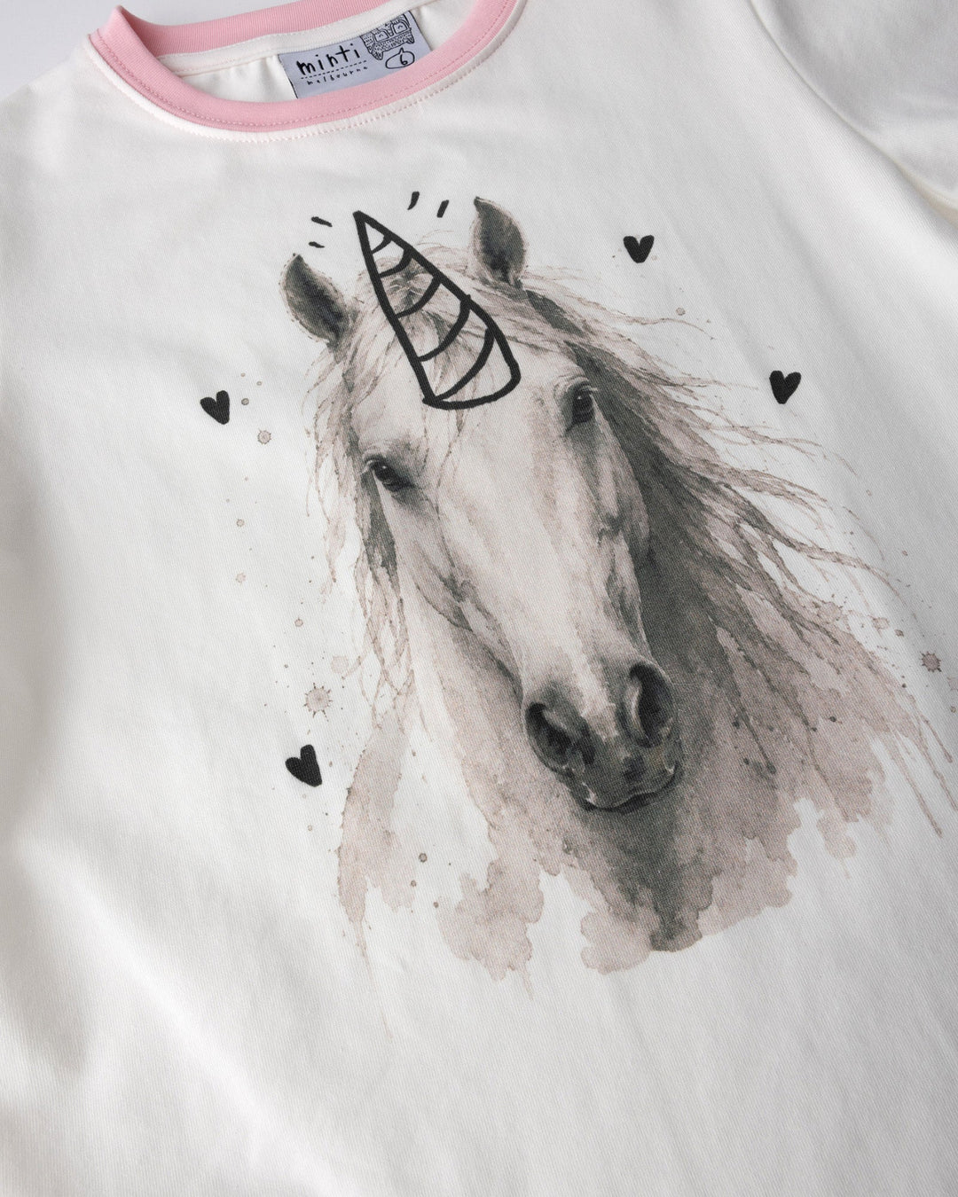 Close up of the Watercolour Unicorn Tee print in white and pink