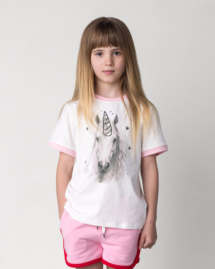 Close up of the Watercolour Unicorn Tee in white and pink on a kid, front view