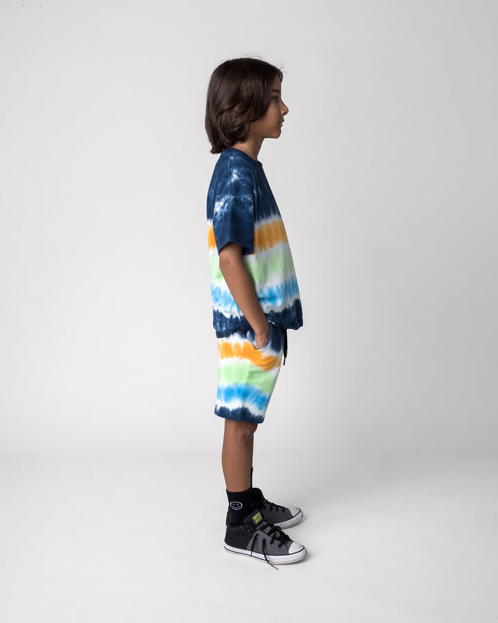 Kid wearing the Airwaves Tee in navy with the Airwaves Short in navy, side view