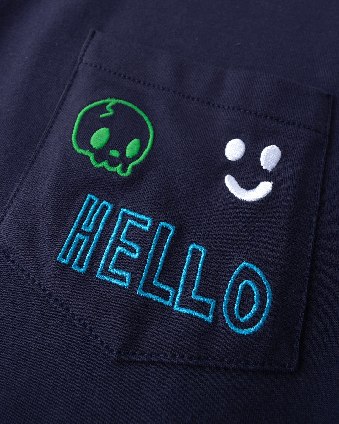 Close up detail of the Badges Tee in ink