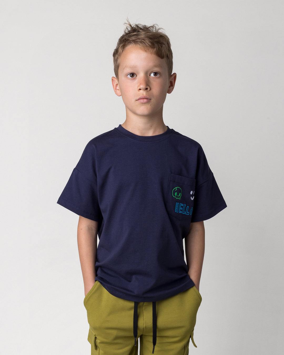 Close up of the Badges Tee in ink on a kid, front view