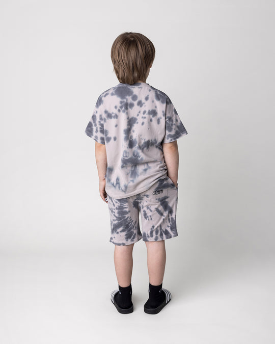 Kid wearing the Splatter Tee in grey with the Splatter Short in grey, back view