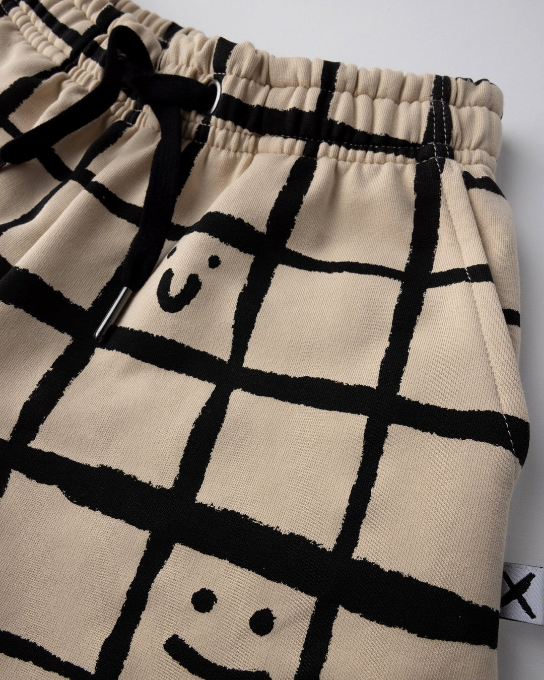 Close up of the Happy Squares Short print in beige