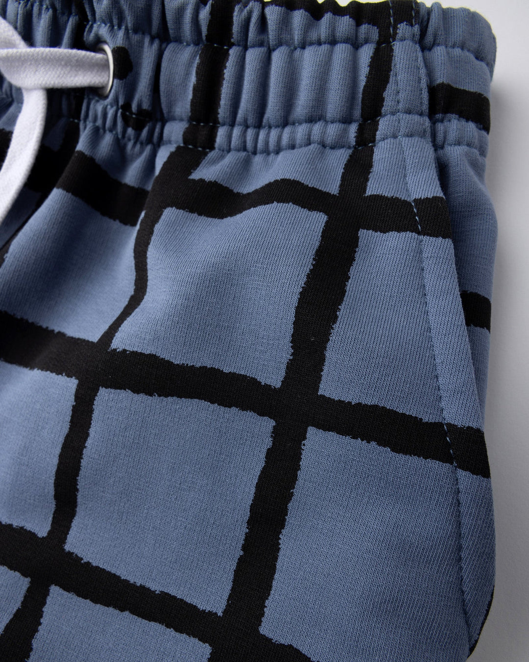 Close up detail of the Happy Squares Short in muted blue