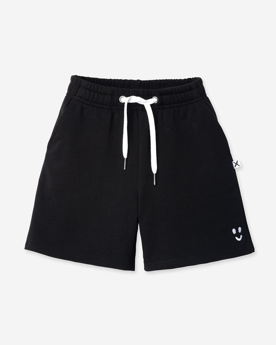 Smile Short in black, kids shorts by Minti, flat lay