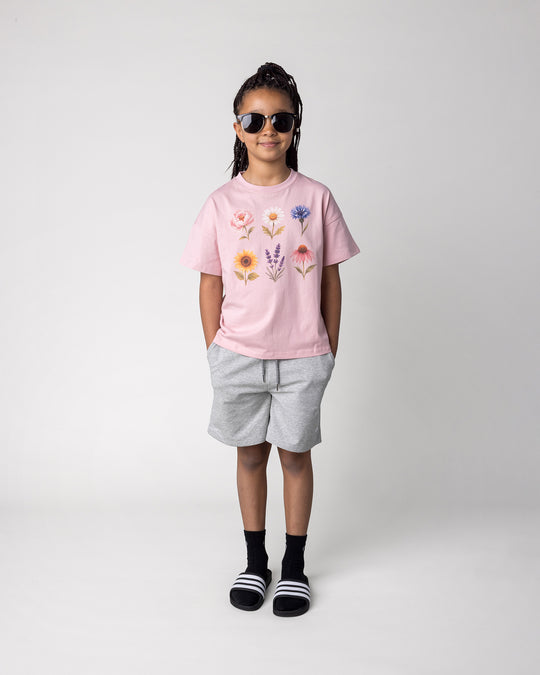 Kid wearing the Smile Short in grey marle with the Flower Friends Tee in muted pink, front view