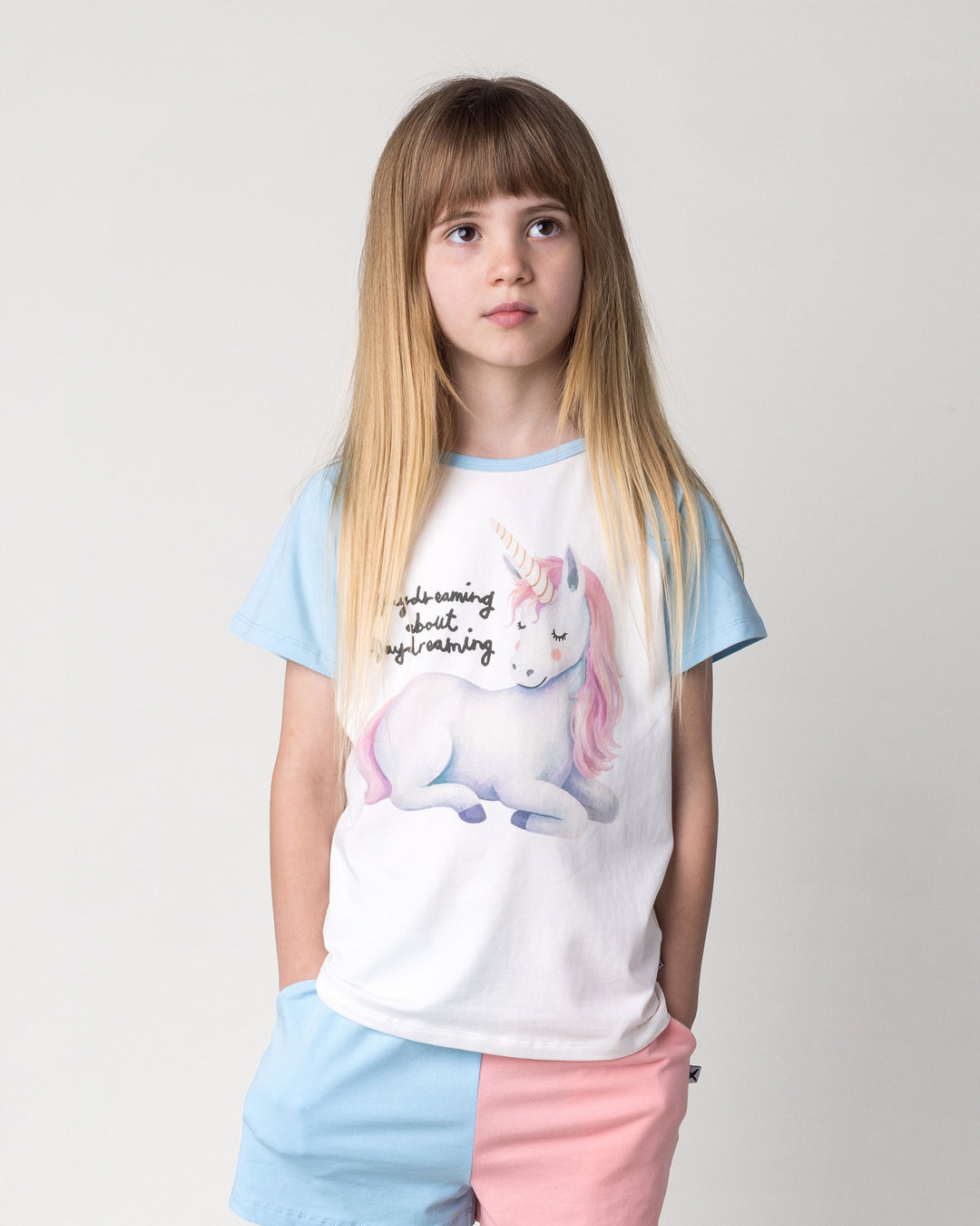 Close up of the Daydreaming Unicorn Tee in white and light blue on a kid, front view