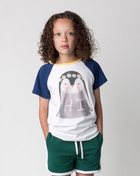 Close up of the Flower Penguin Tee in white, ink and yellow on a kid, front view