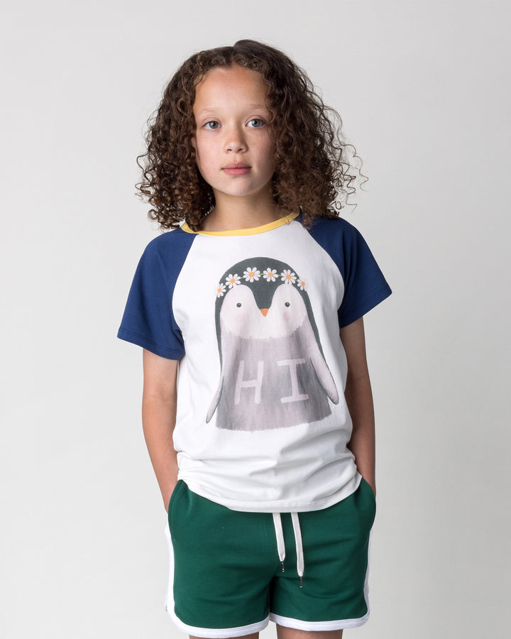 Close up of the Flower Penguin Tee in white, ink and yellow on a kid, front view
