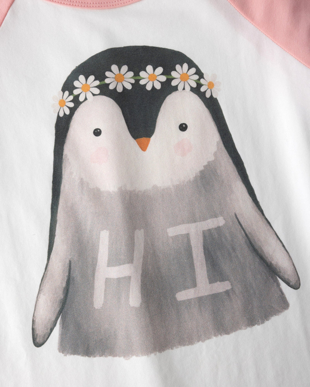 Close up of the Flower Penguin Tee print in white and pink