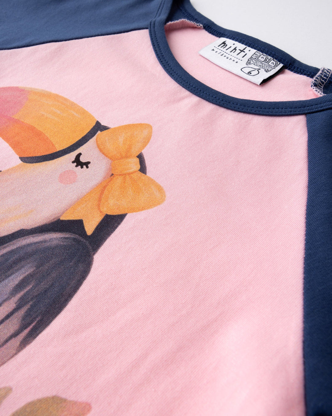 Close up of the Hello Toucan Tee print in ballet and ink